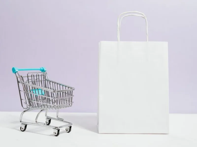 Retail shopping bag and trolley on a studio background