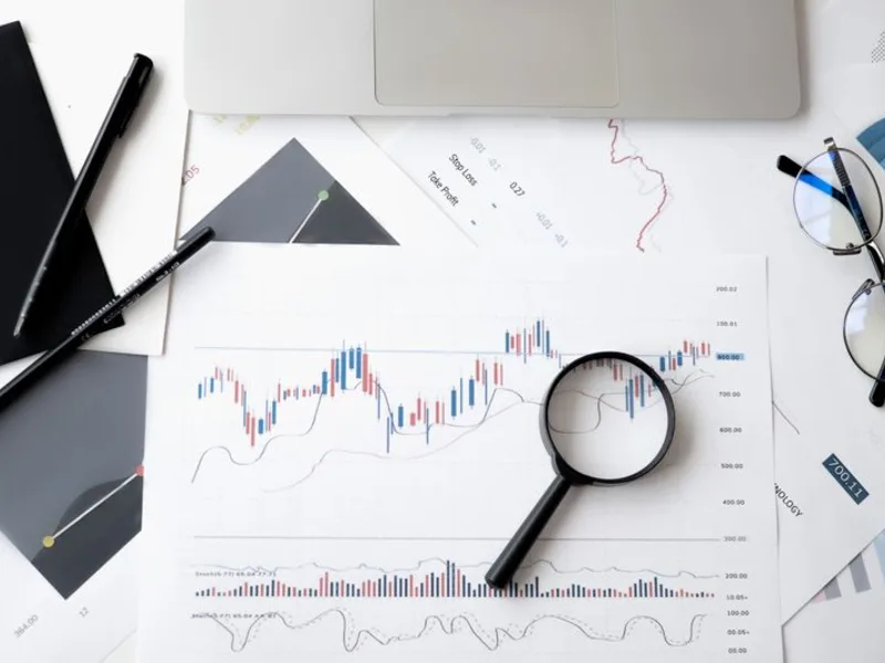 Financial charts being analysed with a magnifier