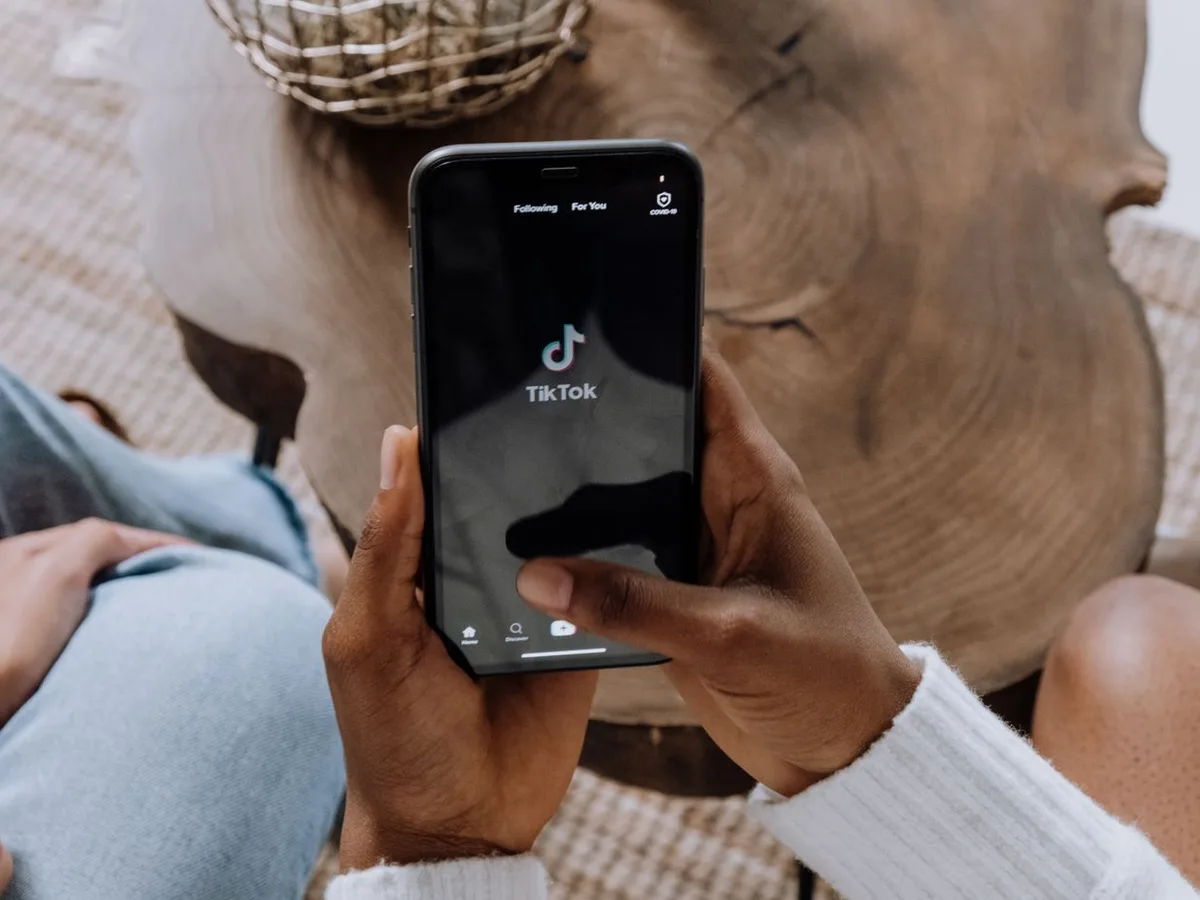 Person scrolling short-form video on a mobile phone